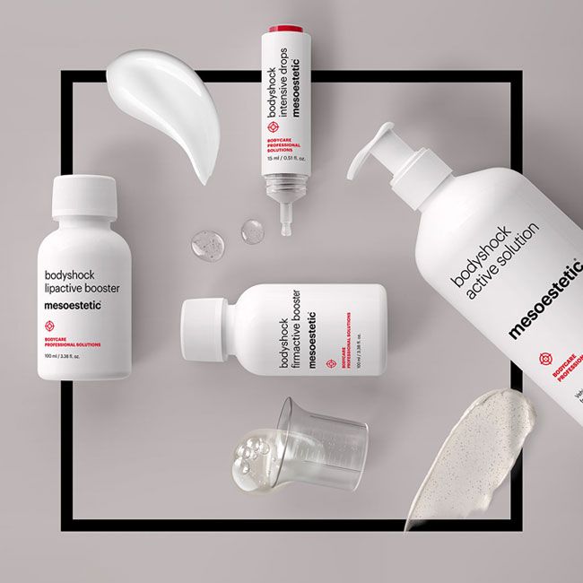 Fünf Mesoestetic bodyshock Hautpflegeprodukte und einige Produkttexturen werden auf einer hellen Fläche mit schwarzem quadratischem Umriss dargestellt, die weiße Flaschen und klare Flüssigkeiten zeigt.