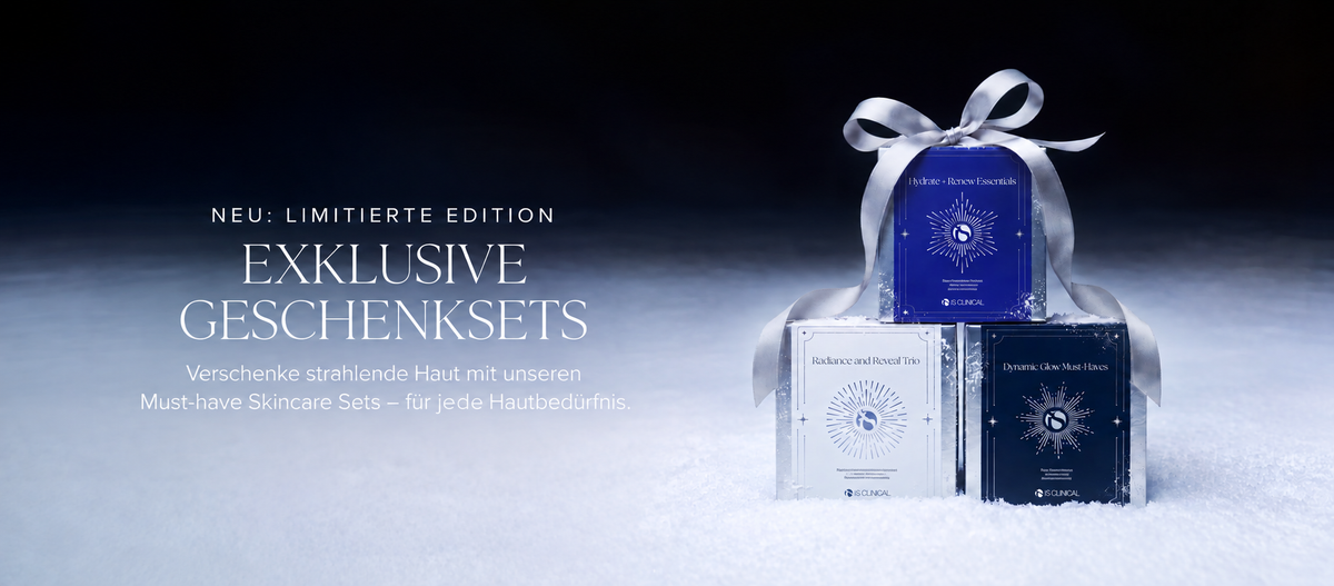 Drei iS Clinical-Hautpflege-Geschenksets, mit einem silbernen Band verziert, präsentiert auf einer schneebedeckten Fläche, begleitet von einem Text, der für exklusive Geschenksets in limitierter Auflage wirbt.