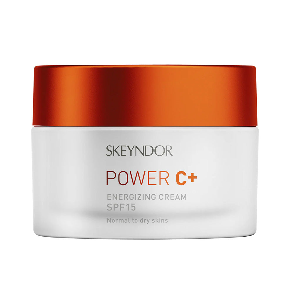 Ein weißer Tiegel mit orangefarbenem Deckel und der Aufschrift "Skeyndor POWER C+ ENERGIZING CREAM", geeignet für normale bis trockene Haut.