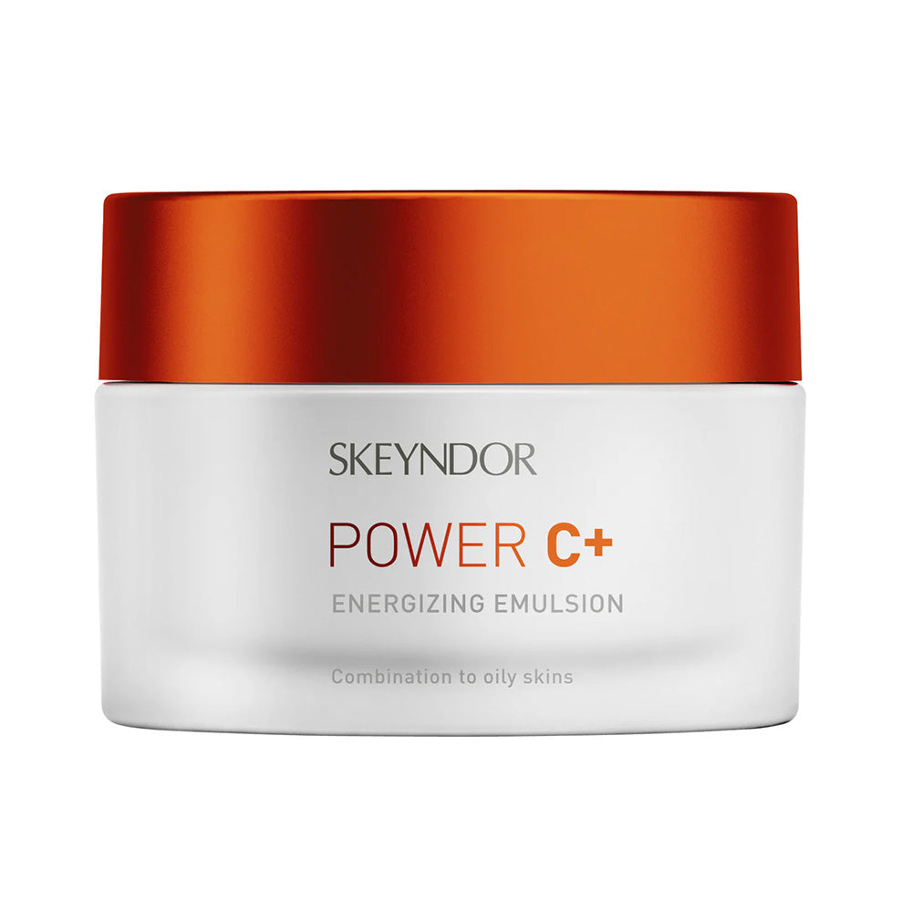 Ein weißer Tiegel mit orangefarbenem Deckel mit der Aufschrift "Skeyndor POWER C+ EMULSION", ein Produkt von Skeyndor für Mischhaut bis fettige Haut.